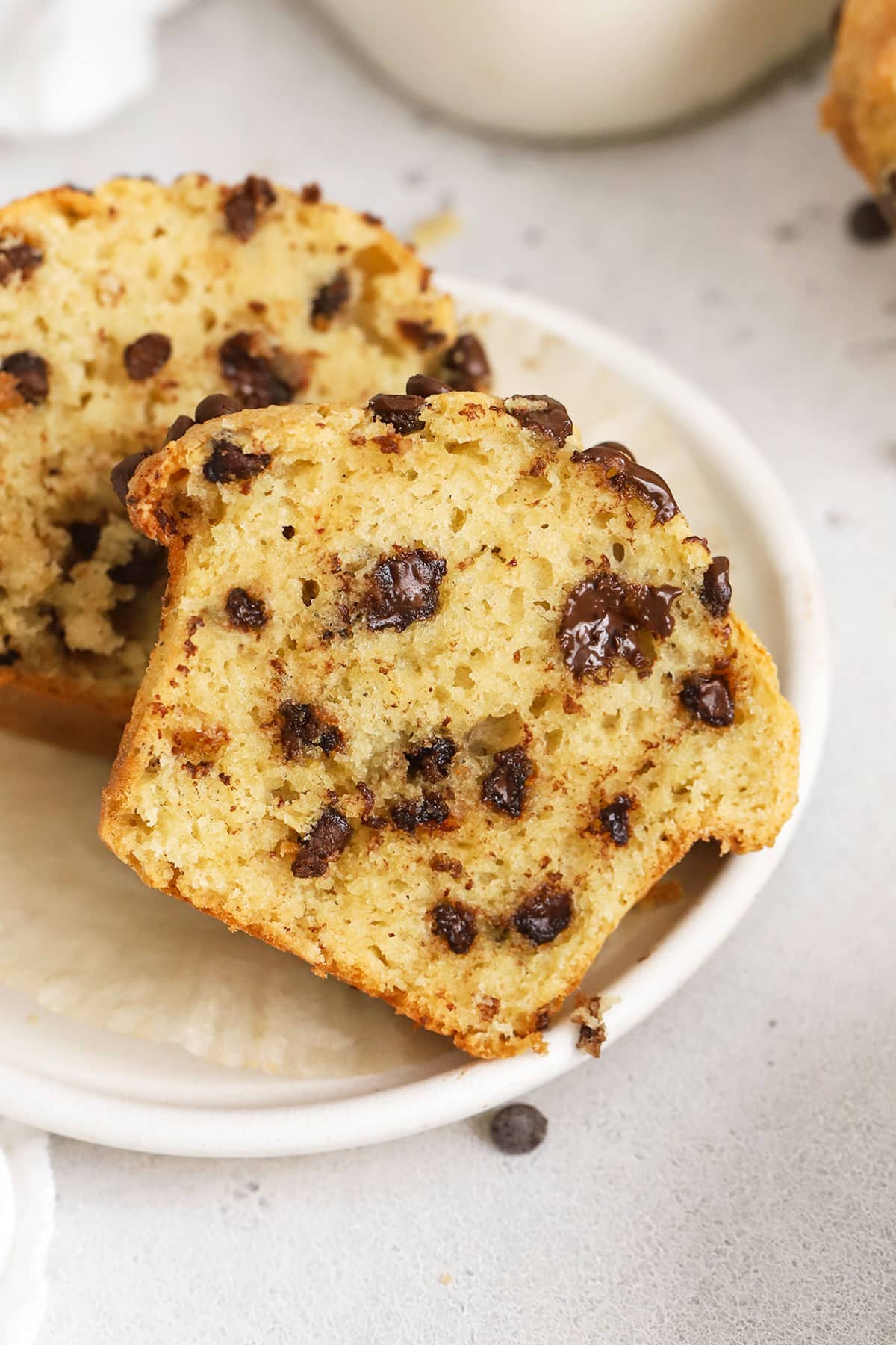 Gluten-free chocolate chip muffins cut in half to show a fluffy center