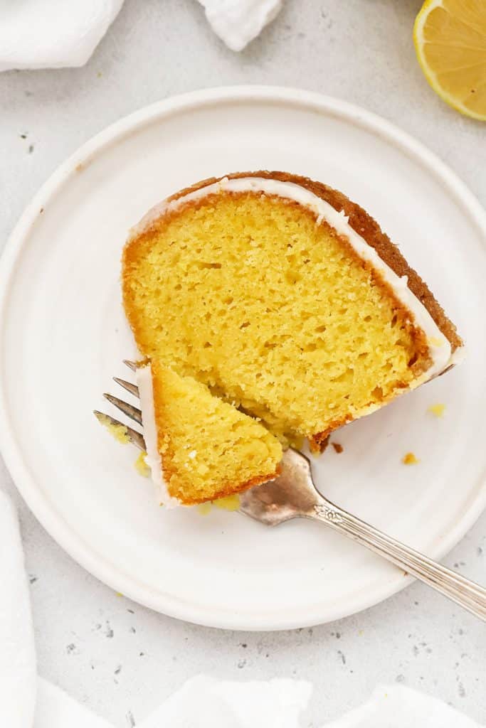 A slice of gluten-free lemon bundt cake on a white plate