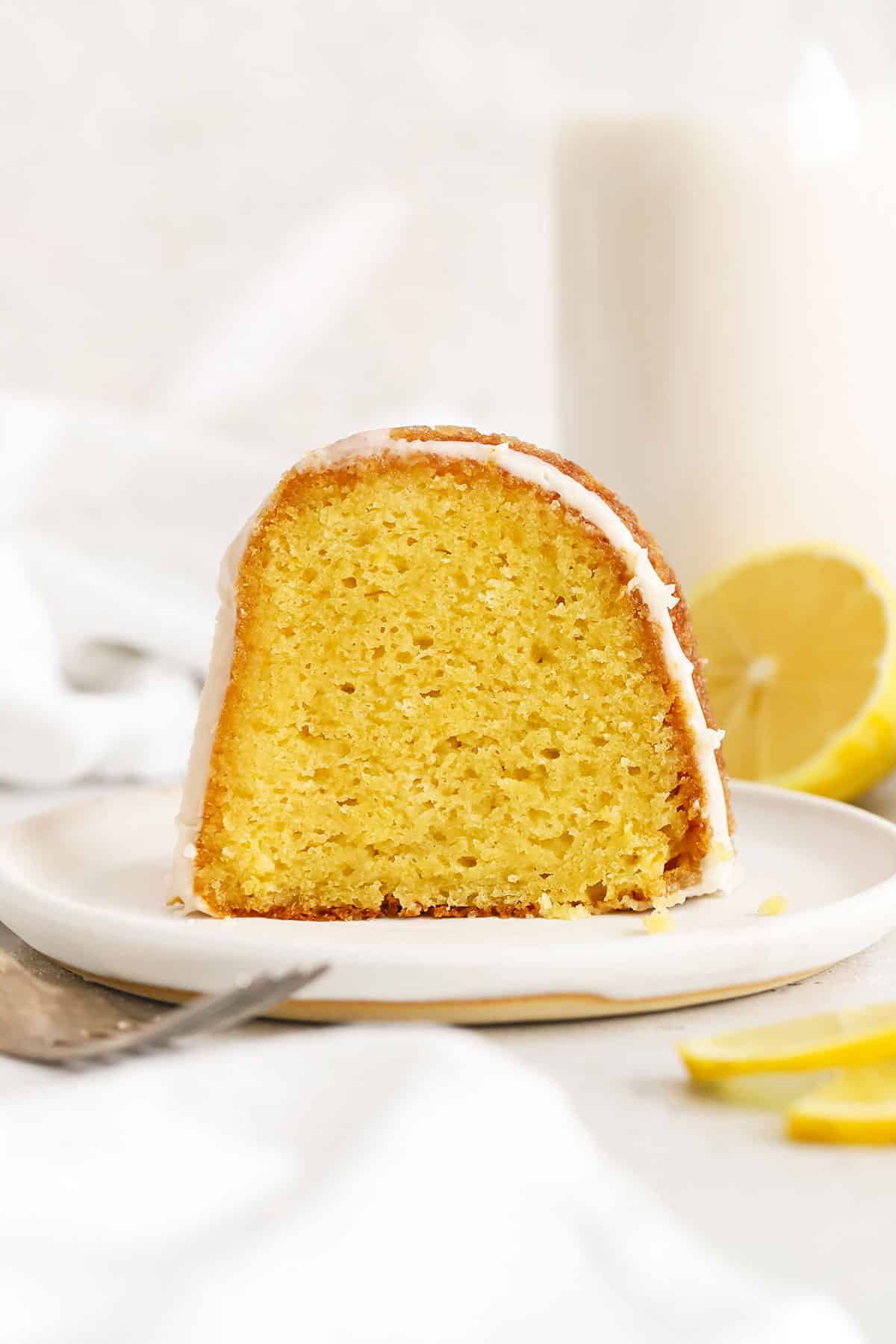 A slice of gluten-free lemon bundt cake on a white plate