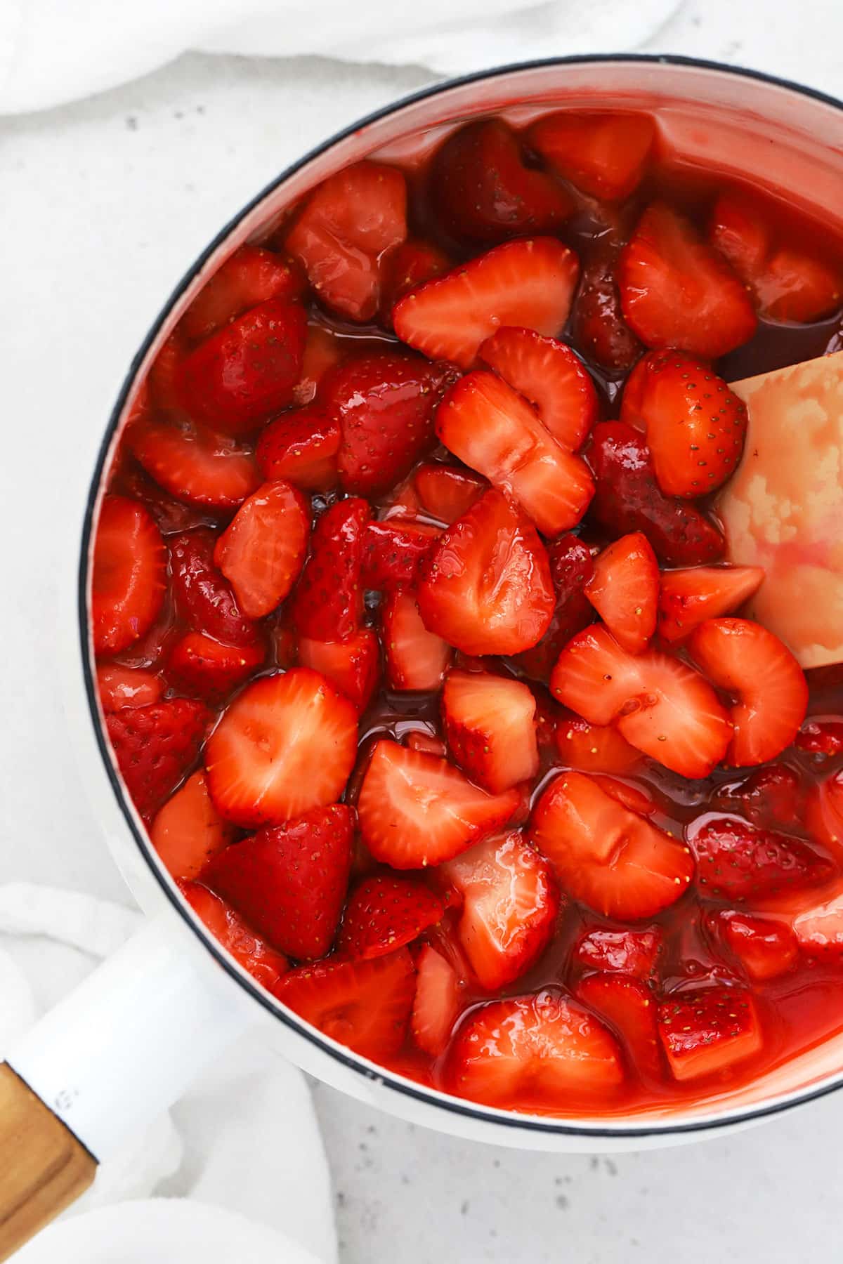 thick strawberry sauce in a white saucepan
