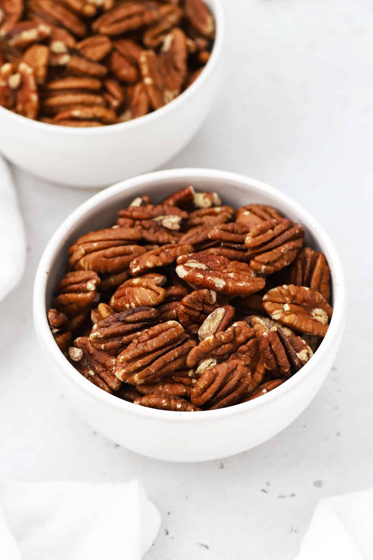 Two bowls of toasted pecans