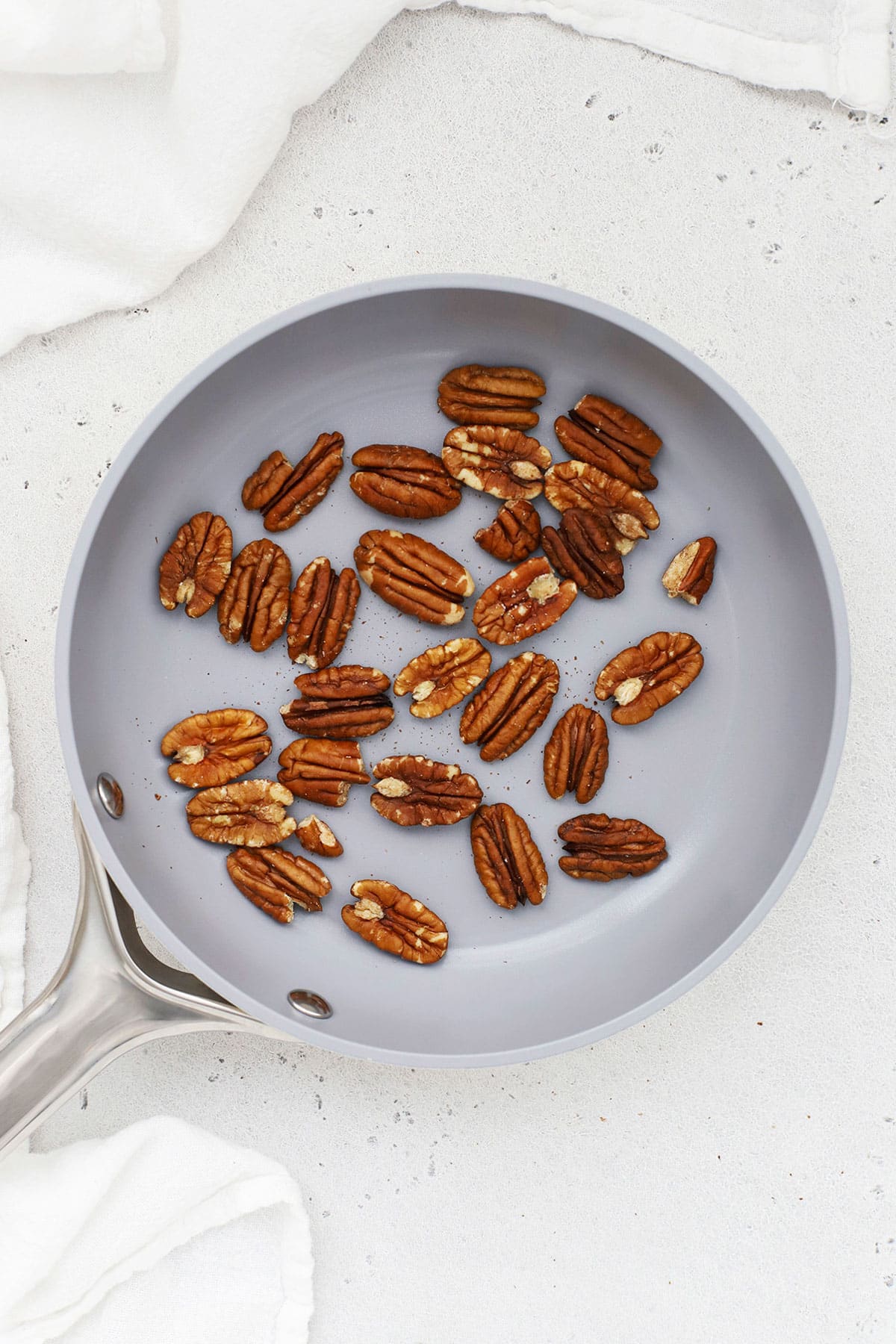 Toasting pecans in a pan on the stove