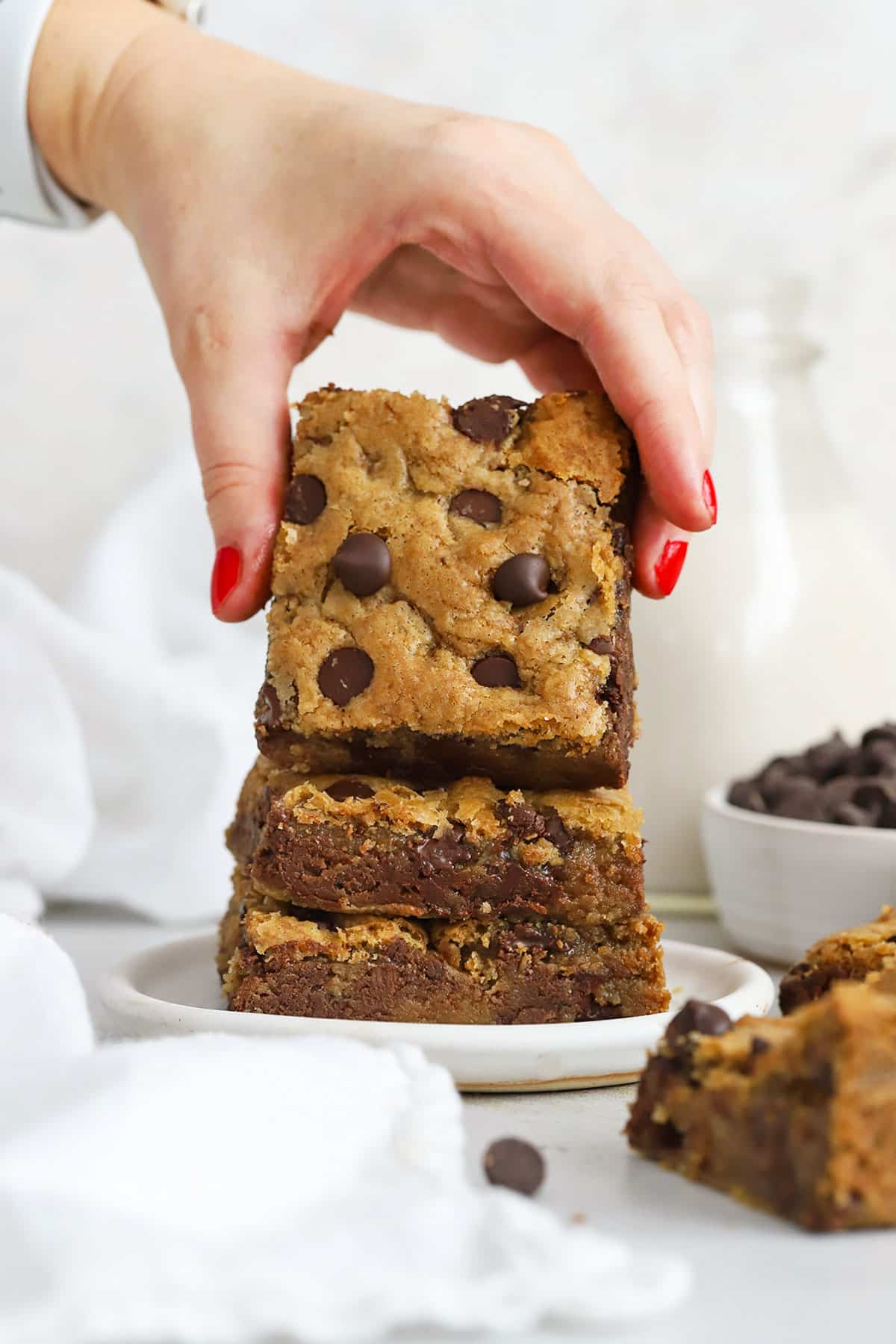 Our easy Gluten-Free Chocolate Chip Cookie Bars recipe is the perfect cookie bar for a crowd! We love the thick, chewy texture and plenty of chocolate in every bite! / gluten-free chocolate chip blondies / gluten free cookie bars / gluten free bar cookie / gluten-free blondie bars / gluten free blondies / gluten-free blondie recipe / gluten-free cookie bar recipe / easy gluten-free dessert / gluten-free cookie bars recipe