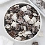 a bowl of cookies and cream muddy buddies with chopped gluten-free oreos