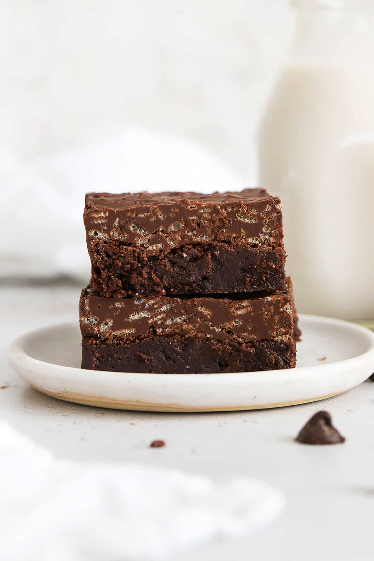 two gluten-free crunch brownies on a white plate