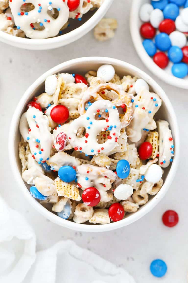 red white and blue chex mix in white bowls