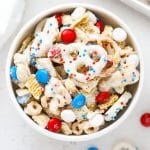 red white and blue chex mix in white bowls