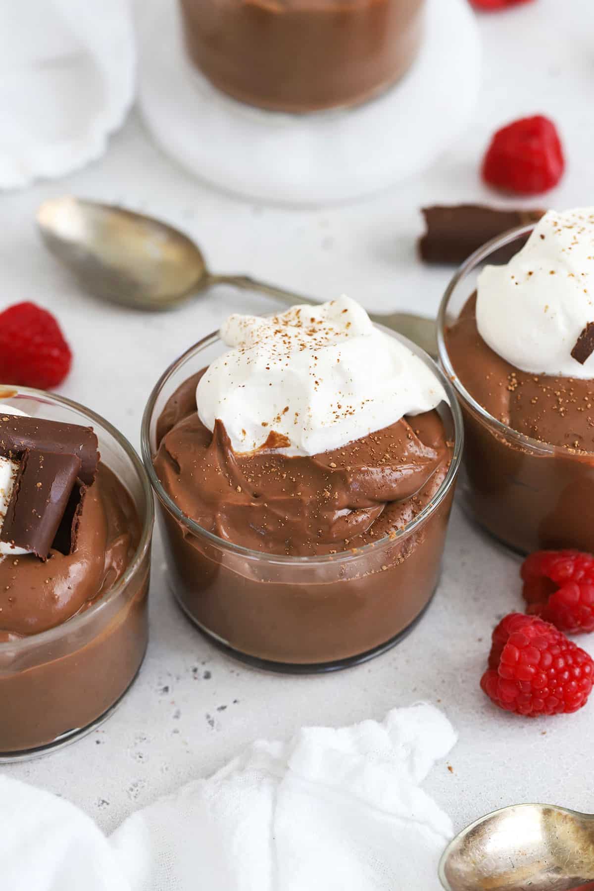 homemade gluten-free chocolate pudding topped with whipped cream