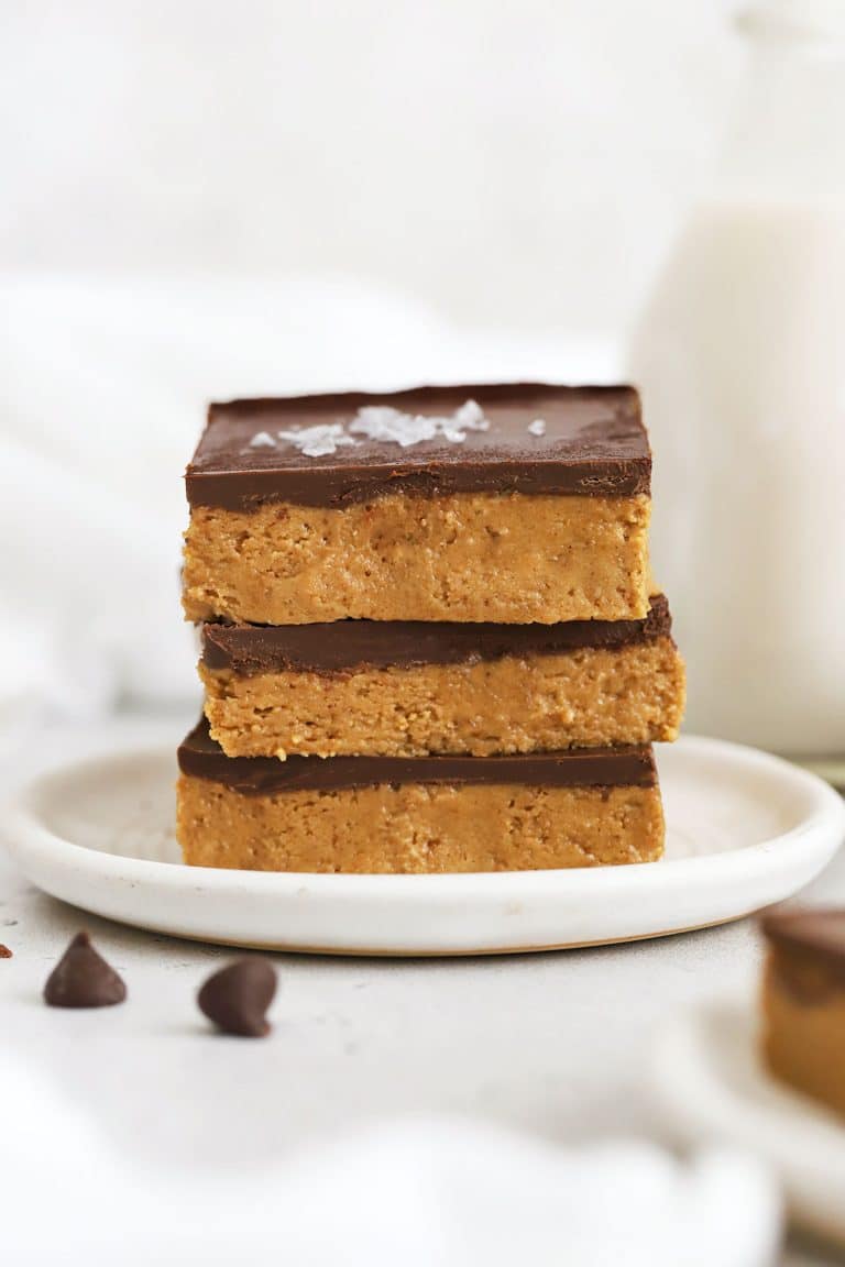 gluten-free chocolate peanut butter bars stacked on a white plate