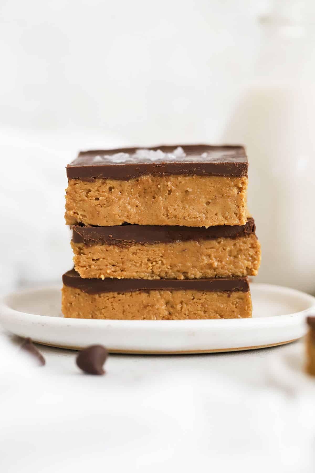 gluten-free chocolate peanut butter bars stacked on a white plate