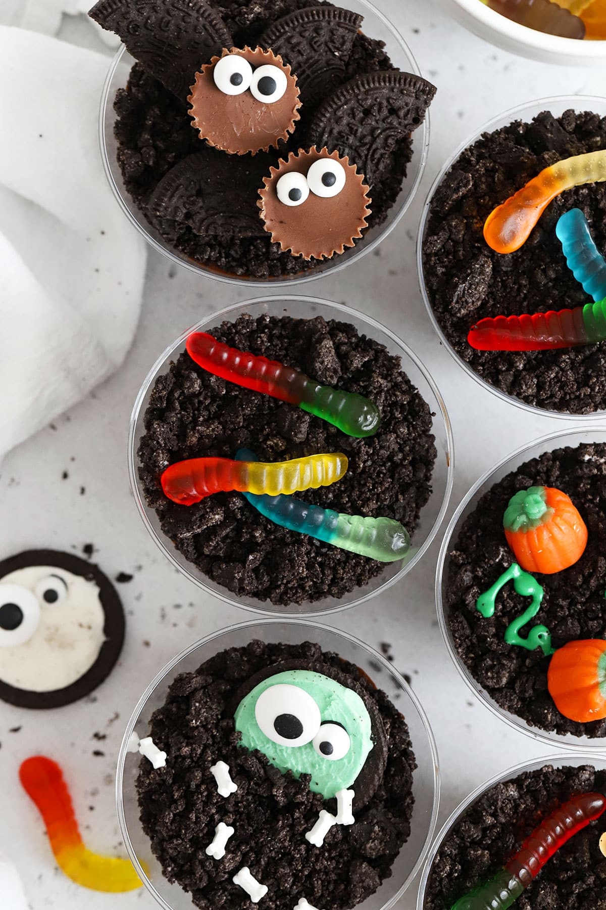 gluten-free Halloween dirt pudding decorated to look like bats, monsters, pumpkins, and more