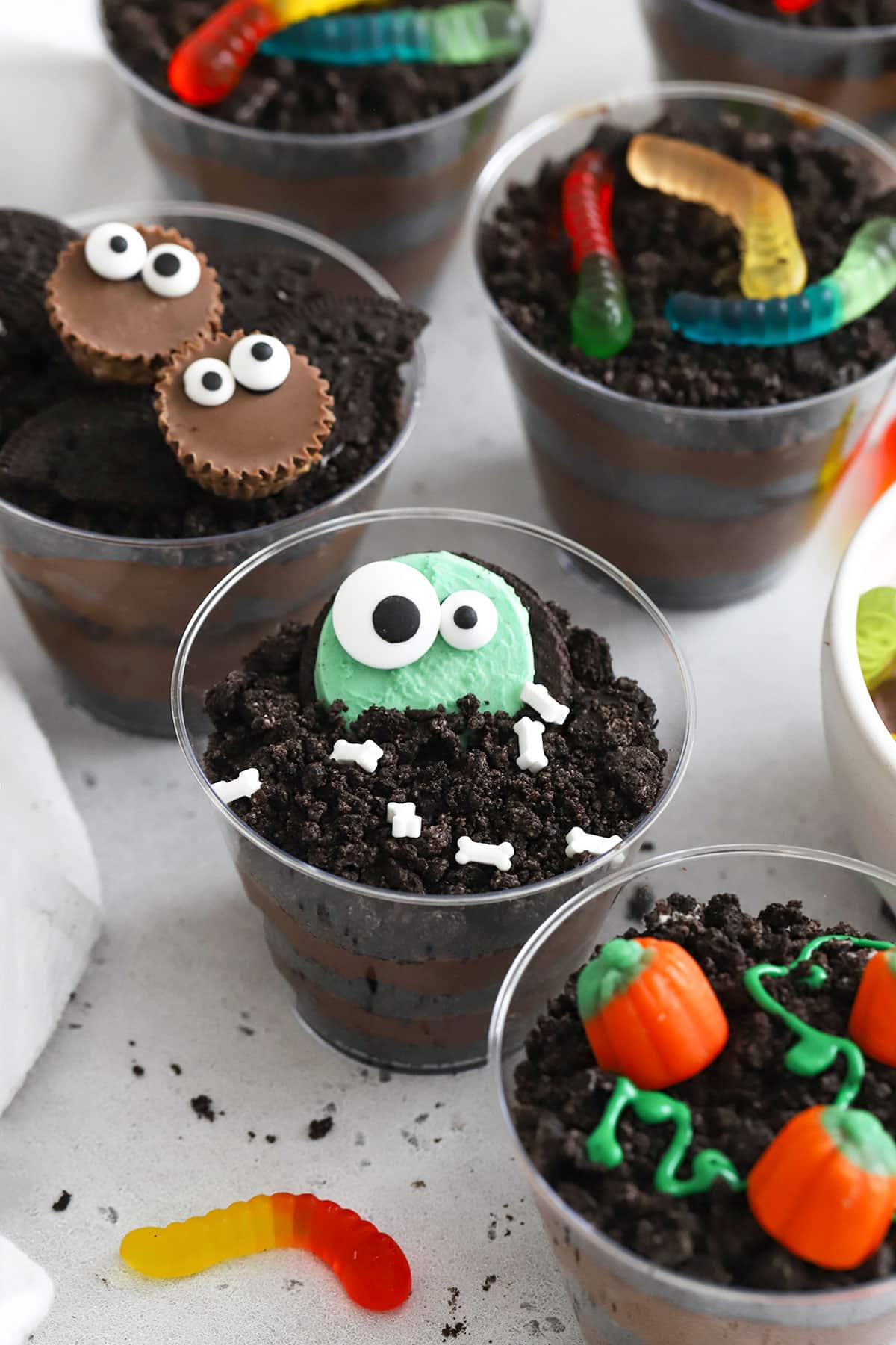 gluten-free Halloween dirt pudding decorated to look like bats, monsters, pumpkins, and more