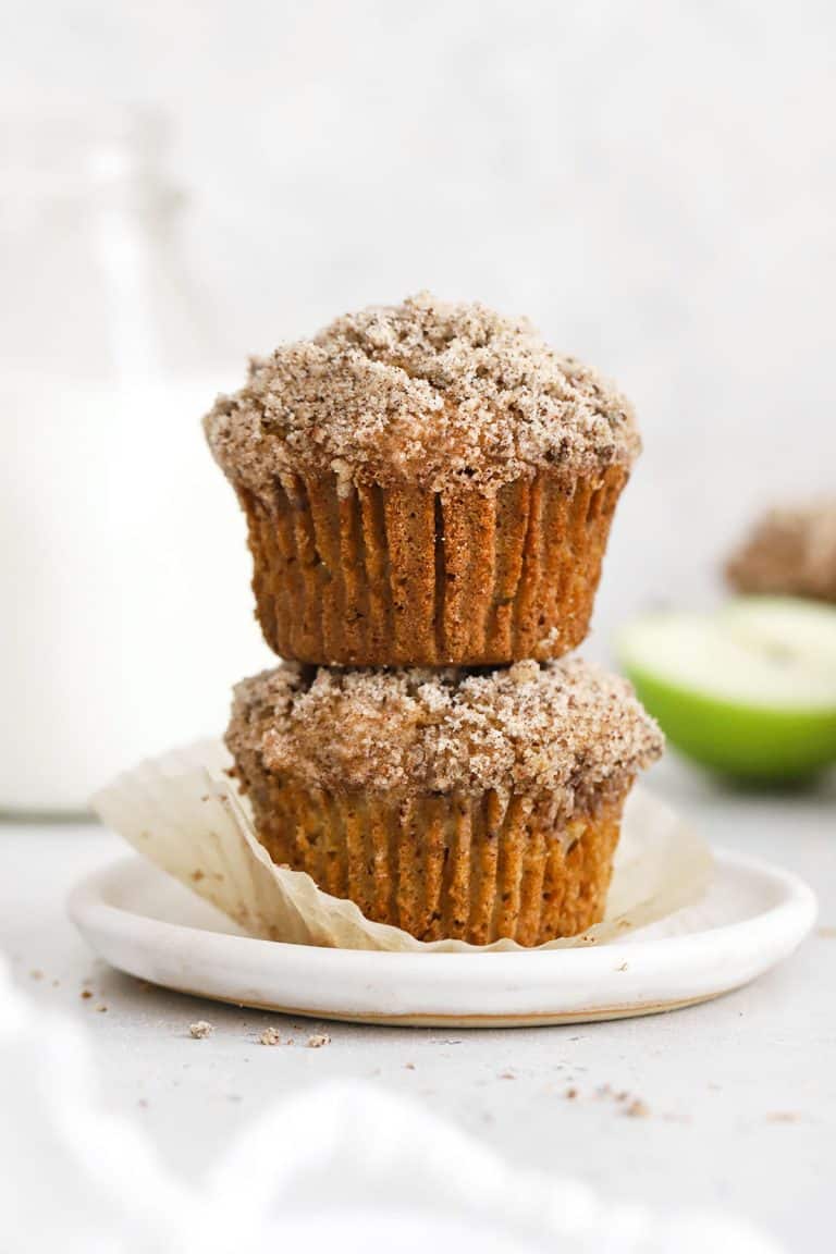 two gluten free apple muffins stacked on a white plate