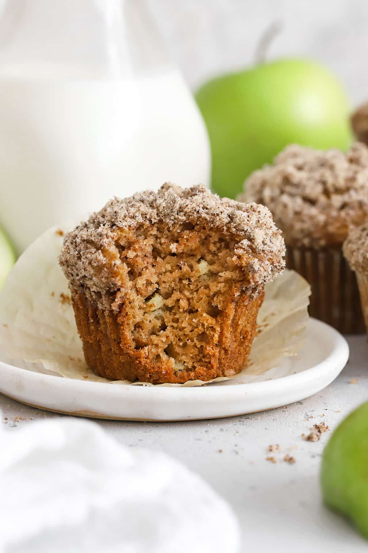 a gluten-free apple muffin with a bite taken out of it