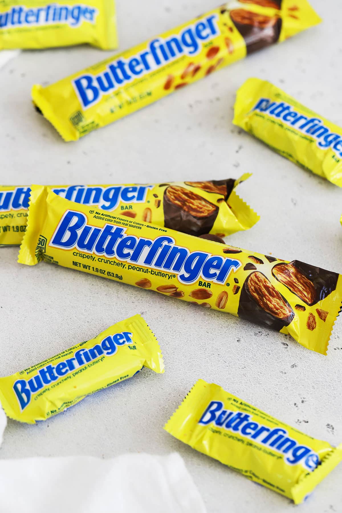 different sizes of Butterfinger candy bars on a white background