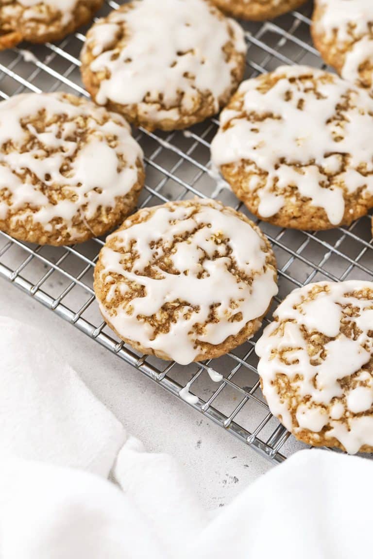 gluten-free iced oatmeal cookies on a cooling rack