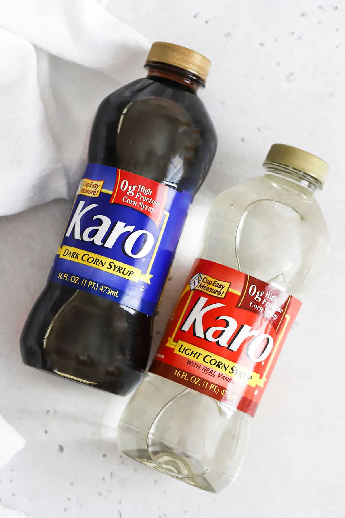 two bottles of corn syrup on a white background