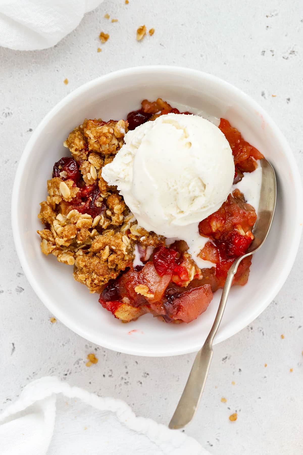 gluten-free cranberry crisp with a scoop of vanilla ice cream on top