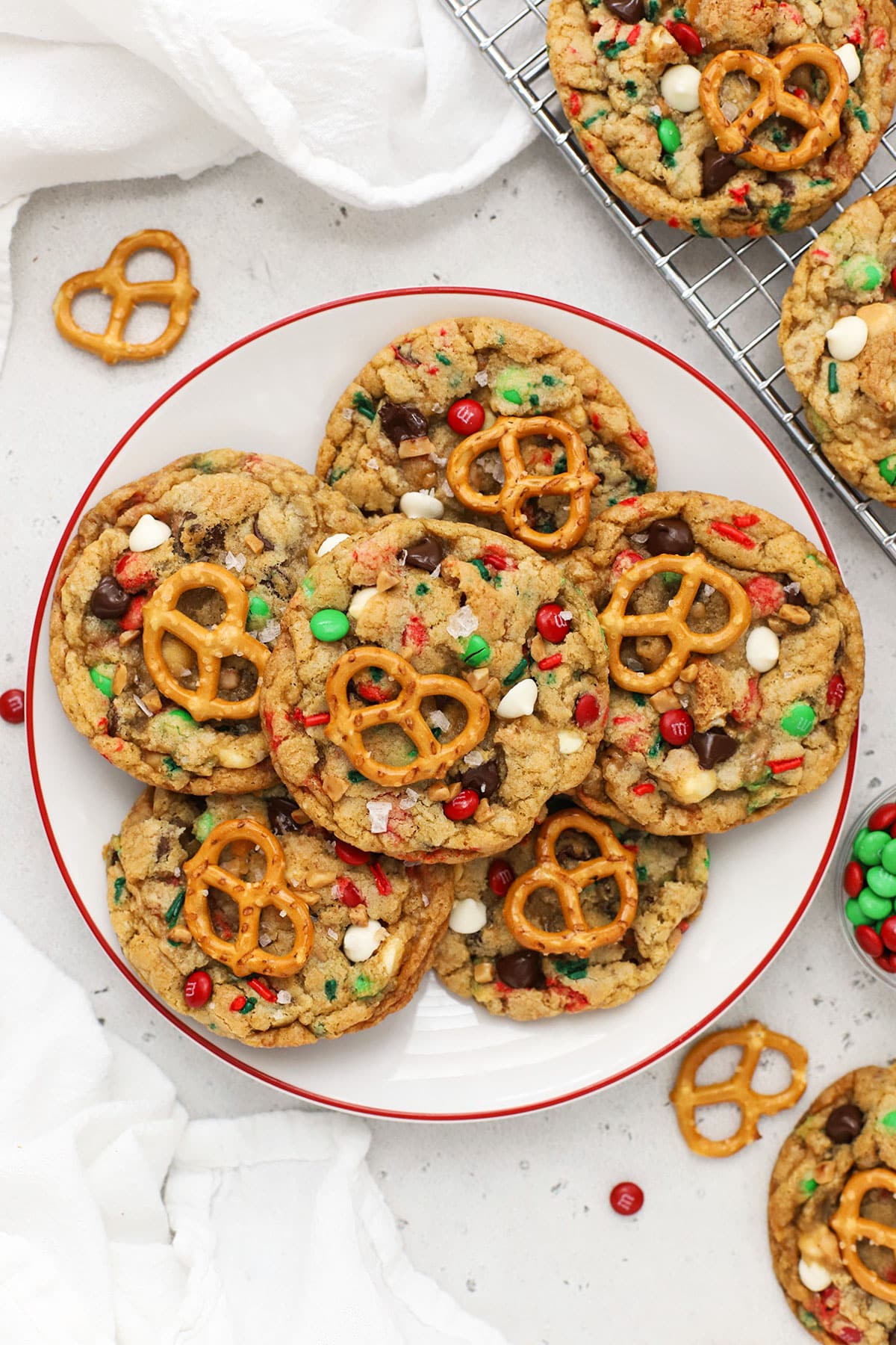 gluten-free Christmas kitchen sink cookies on a white plate with a red rim