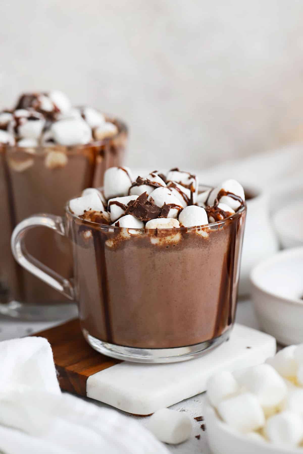 homemade hot chocolate topped with marshmallows and chocolate syrup
