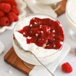 Danish rice pudding in dessert bowls topped with raspberry sauce