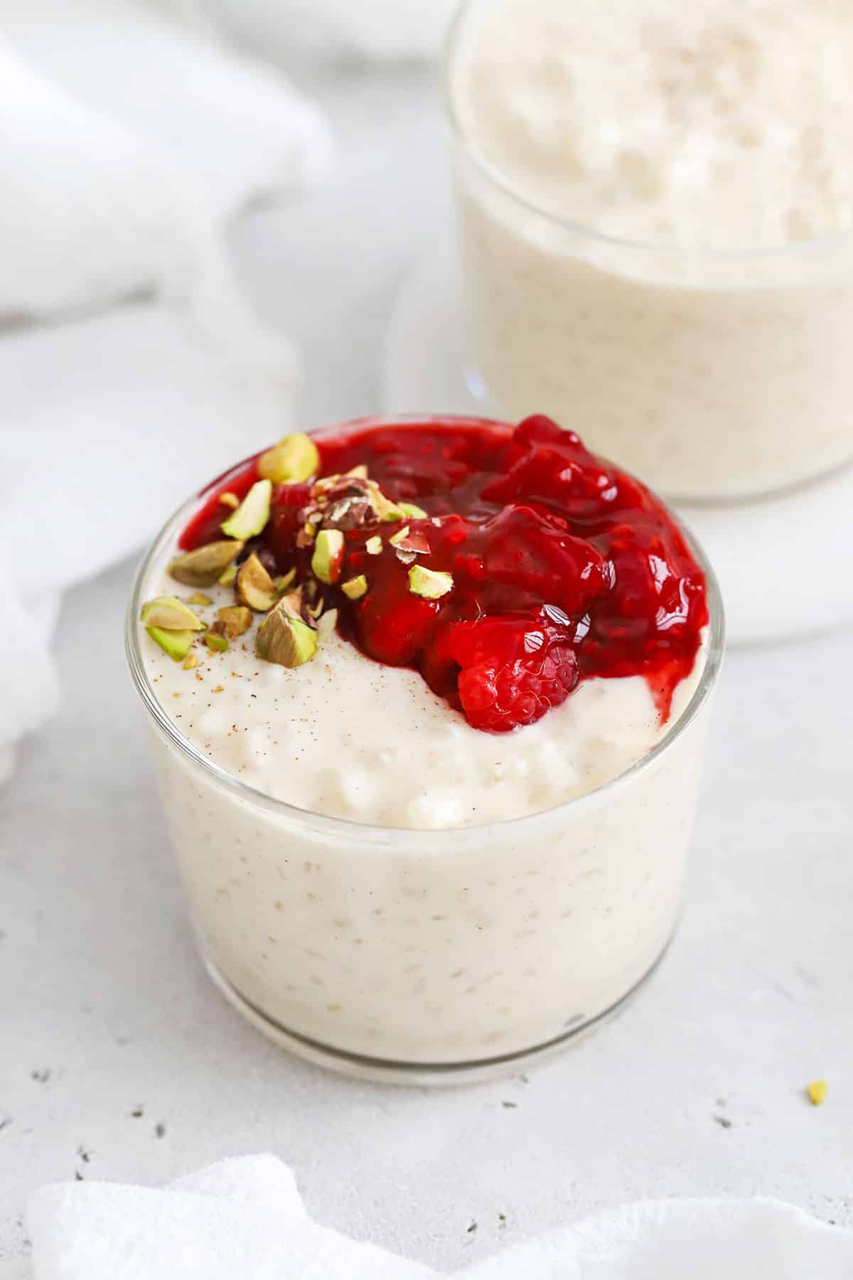 gluten-free rice pudding with raspberry sauce and pistachios