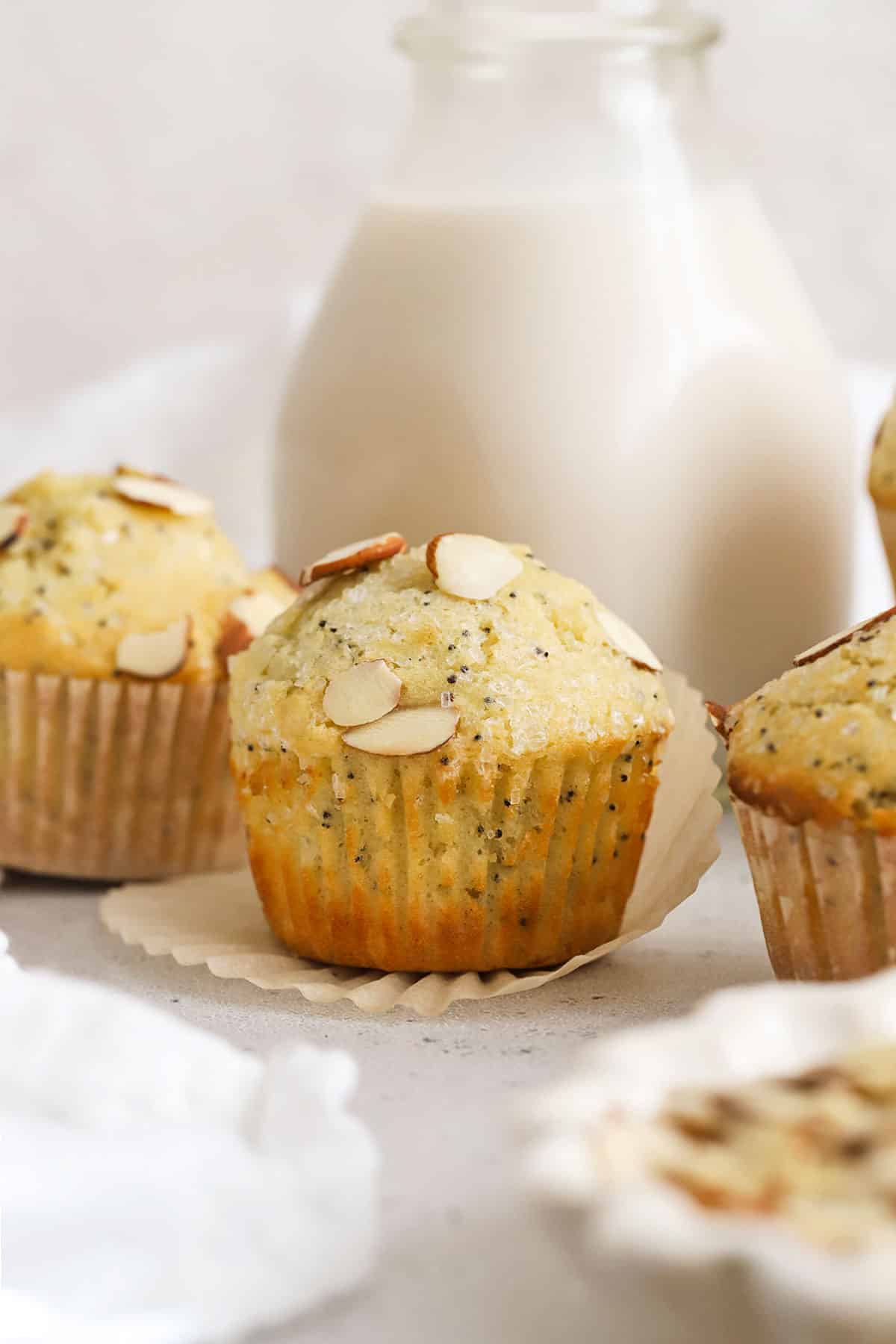 gluten-free almond poppy seed muffins topped with sliced almonds