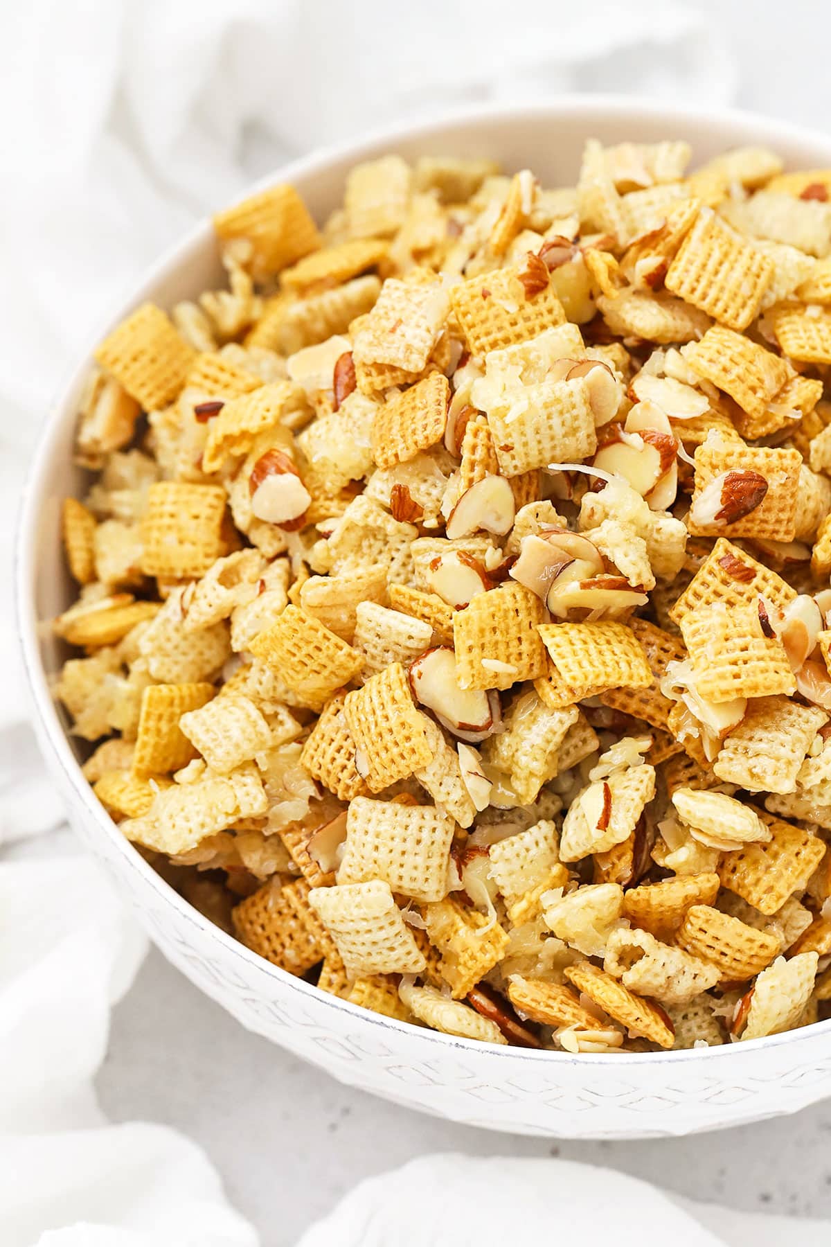 white serving bowl with gluten-free sticky chex mix