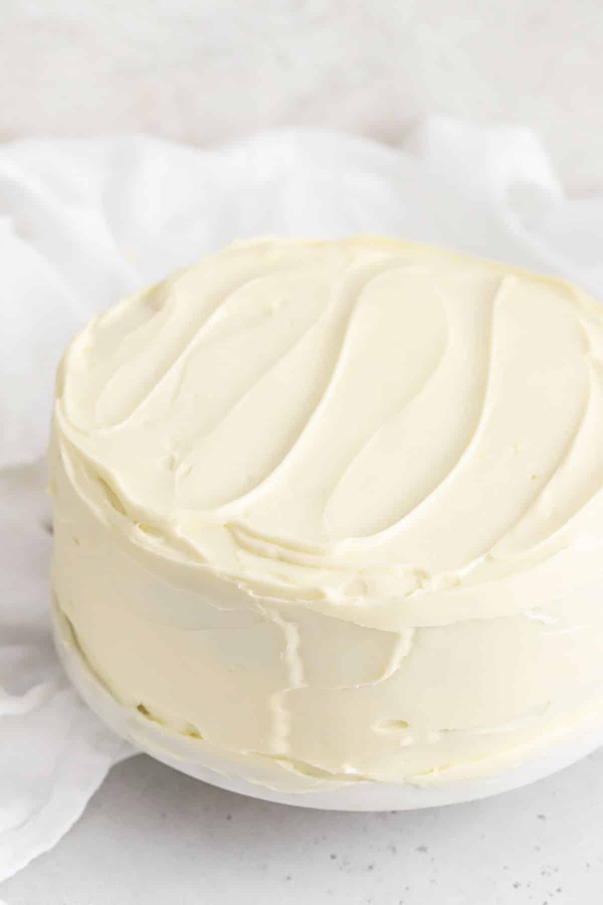 two layer cake frosted with cream cheese frosting