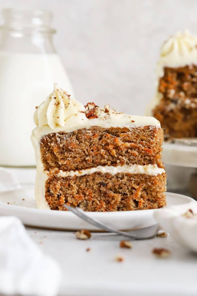 a slice of gluten-free carrot layer cake on a white plate