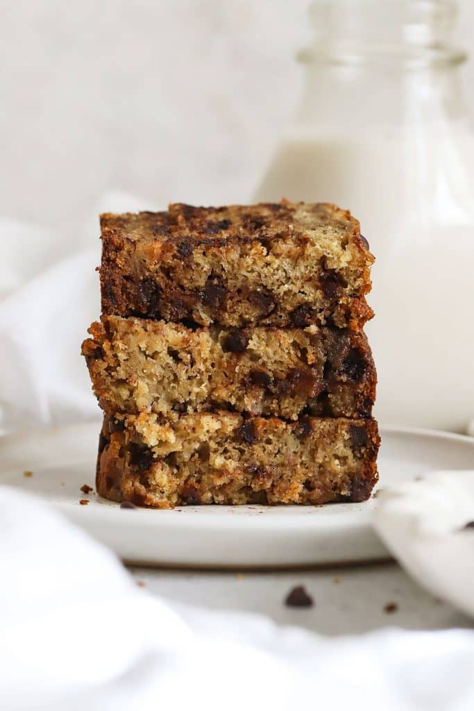 three slices of gluten-free chocolate chip banana bread stacked on a white plate