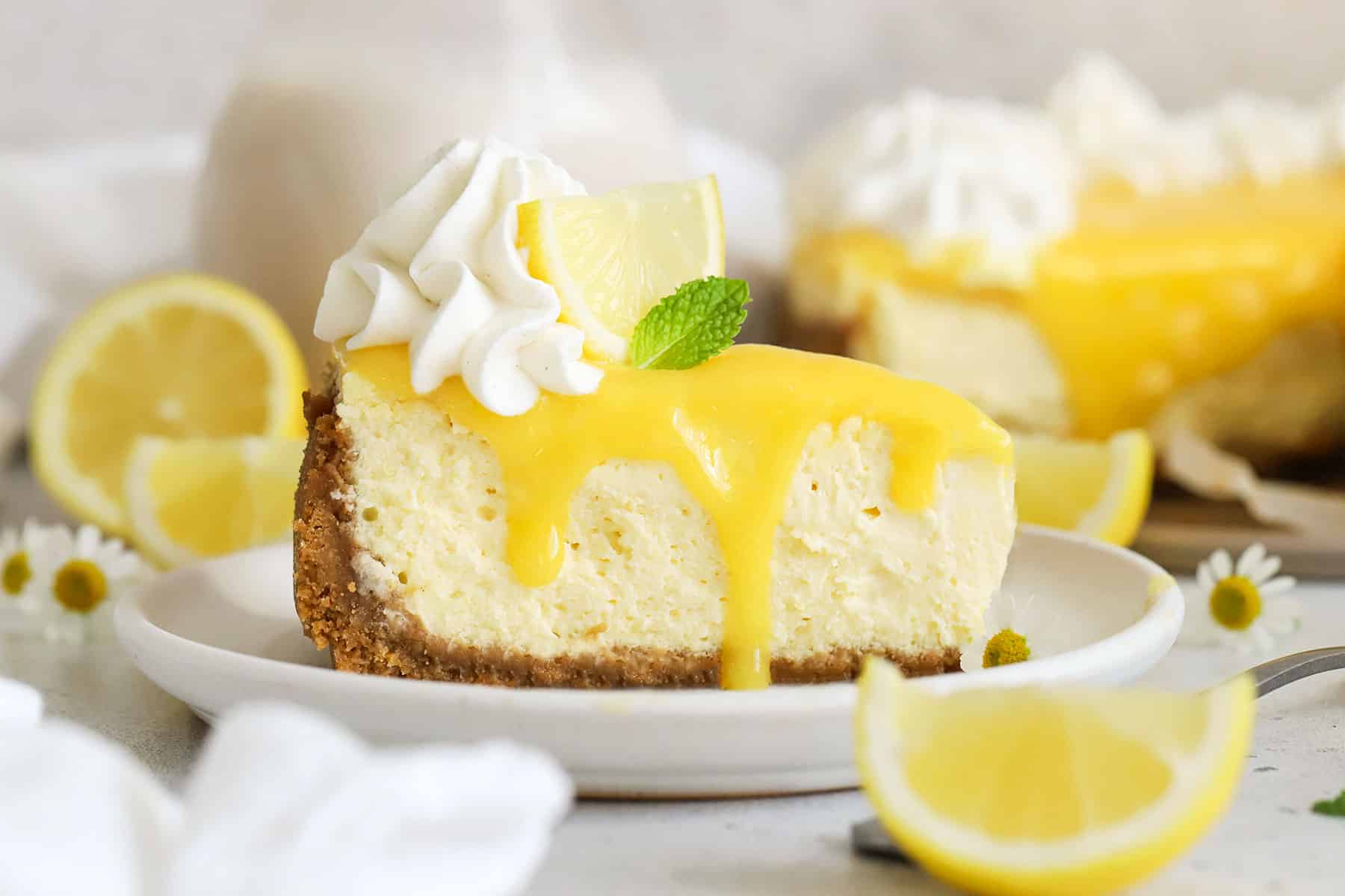 a slice of gluten-free lemon cheesecake with homemade lemon curd