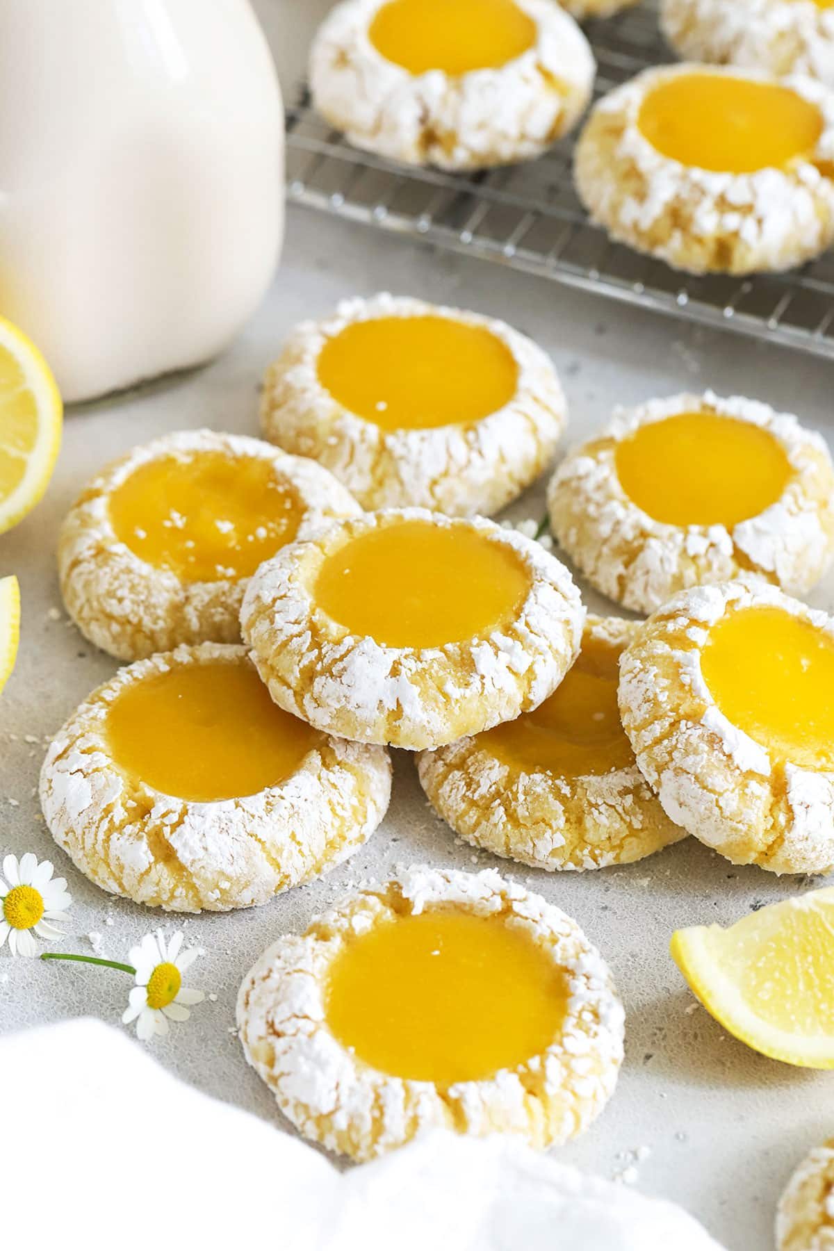 gluten-free lemon thumbprint cookies stacked on a white background