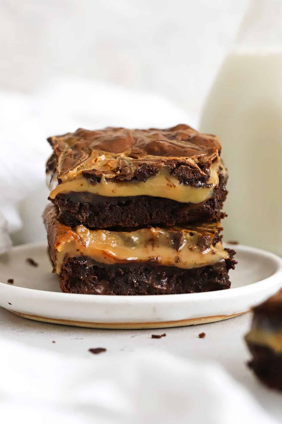gluten-free dulce de leche brownies stacked on a white plate
