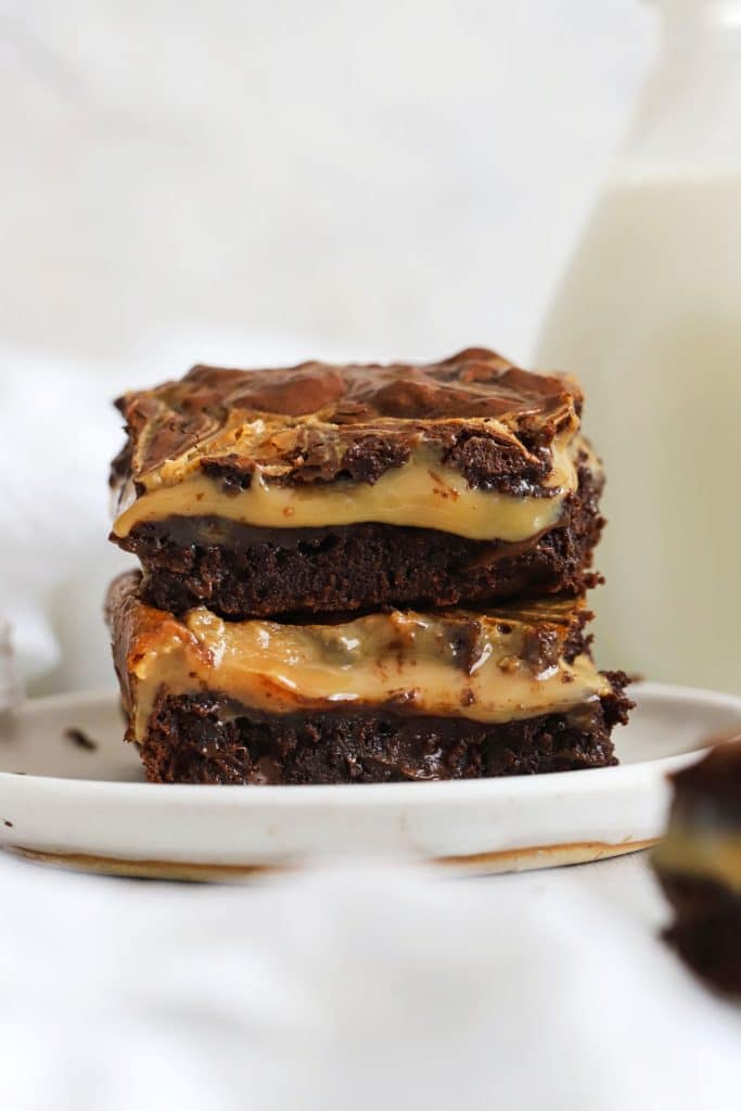 gluten-free dulce de leche brownies stacked on a white plate