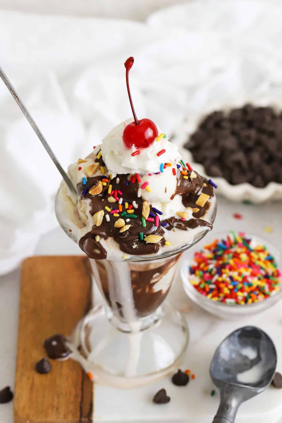 Learn how to make a classic hot fudge sundae! This classic ice cream dessert is a total crowd pleaser (especially with our homemade hot fudge!). Beyond the old-fashioned hot fudge sundae recipe, get TONS of delicious ideas for an ice cream sundae bar, famous ice cream sundae variations, and more. 