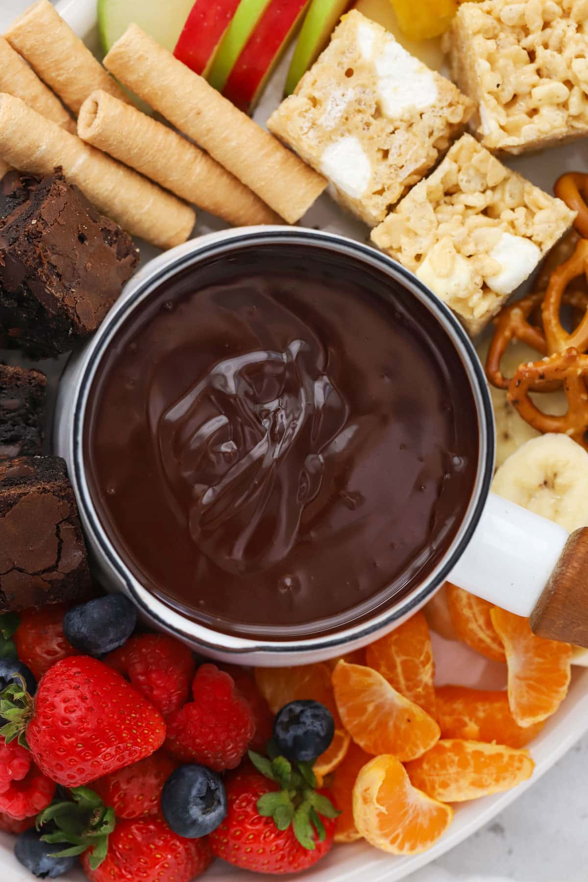 glossy chocolate fondue on a dessert platter
