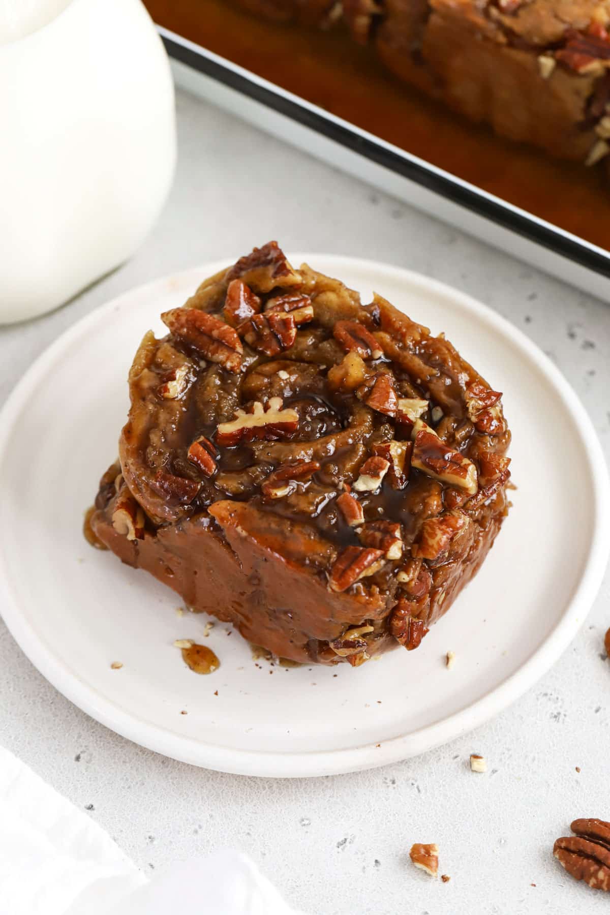 gluten-free caramel pecan sticky bun on a white plate