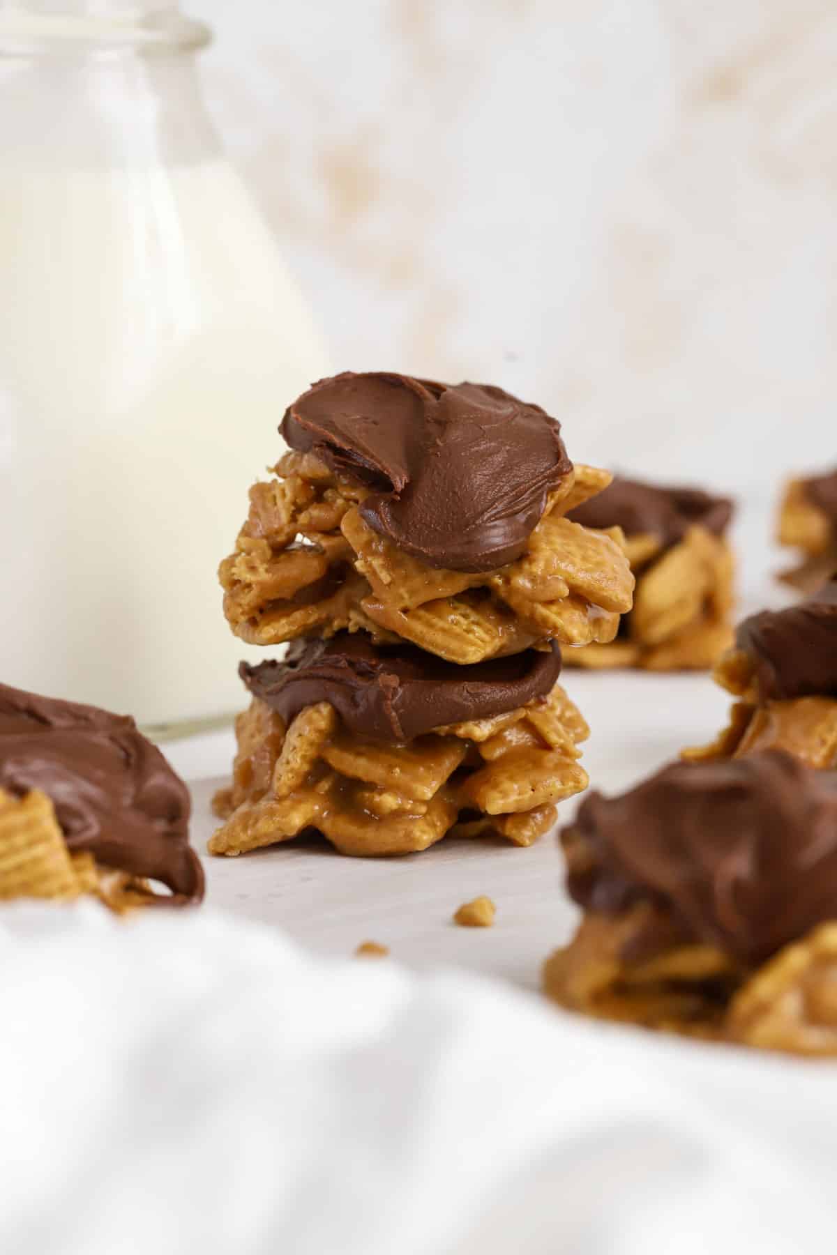 Chex scotcheroos clusters stacked next to a bottle of milk
