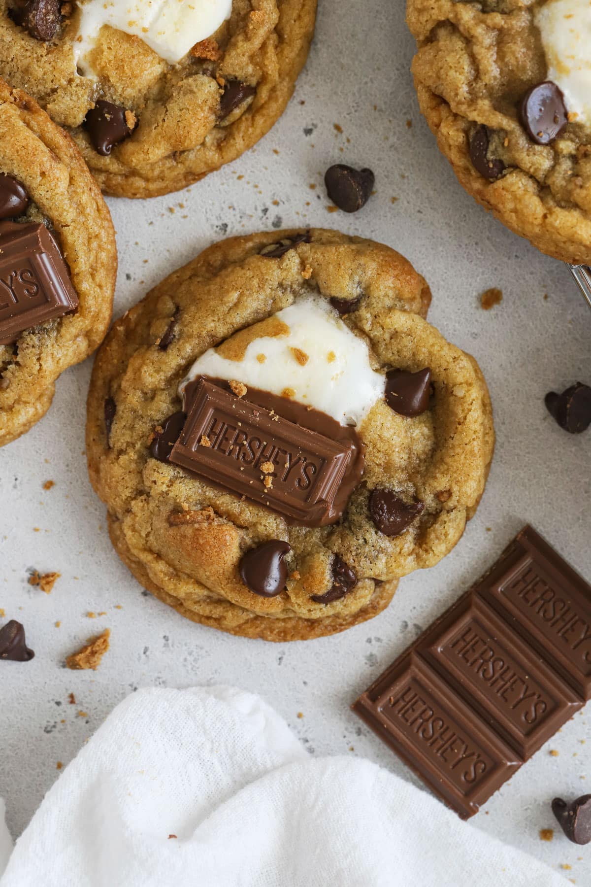 Gluten-free s'mores chocolate chip cookies topped with squares of hershey's chocolate