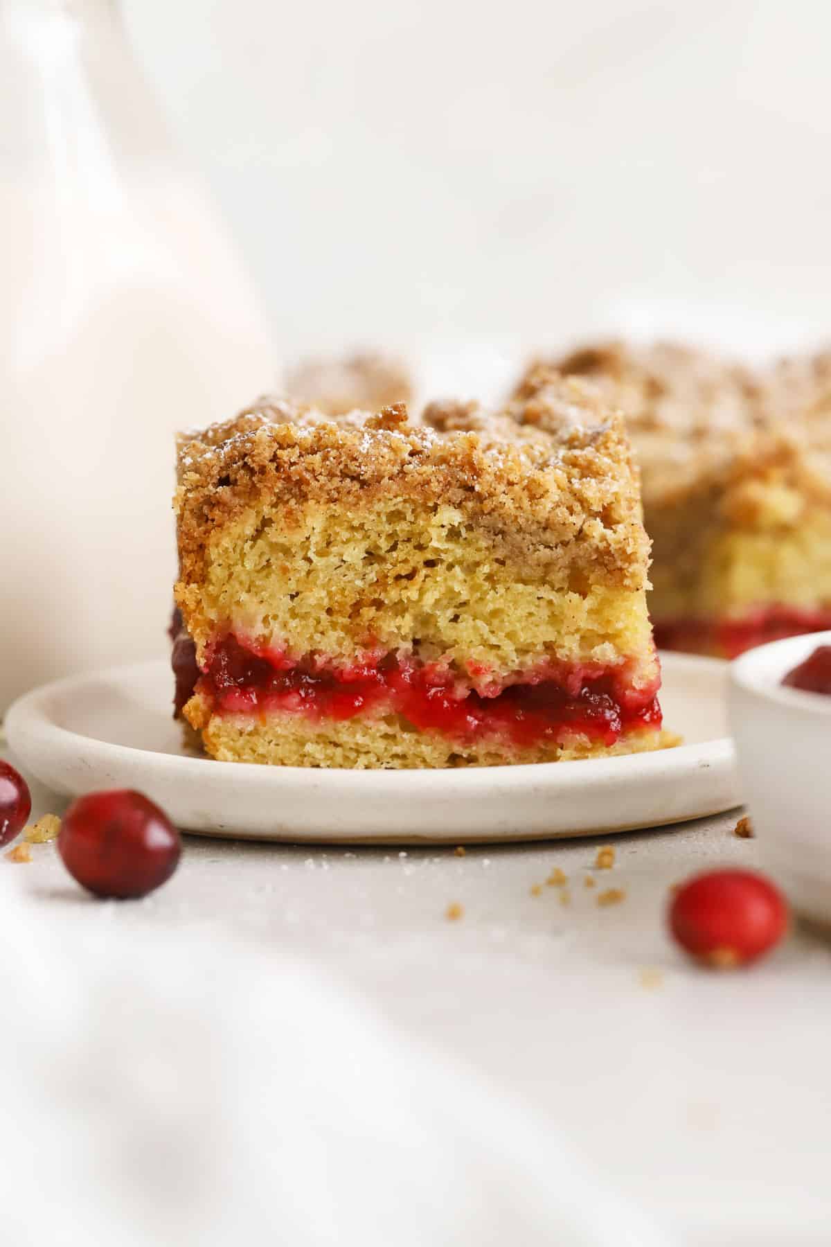A slice of gluten-free cranberry coffee cake made with cranberry sauce